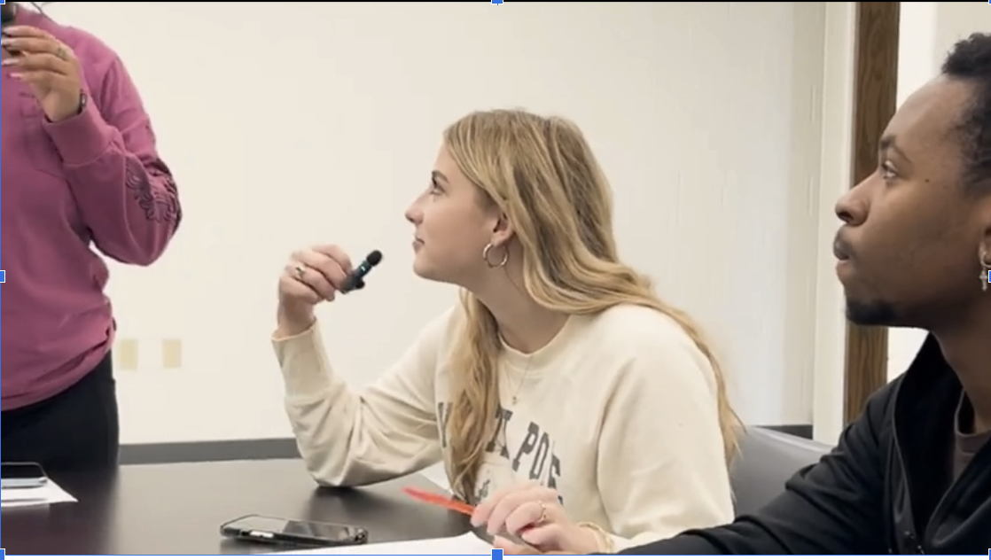 Cheyenne Kingsbury (12), one of the judges for Project Poetry, gets ready to give feedback